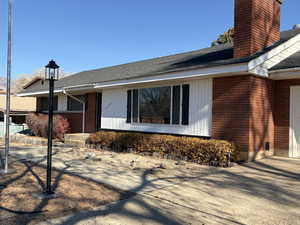Solid brick rambler, newly shingled roof, light & flag pole with a  xeriscaped front yard for conservation and low maintenance