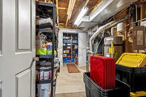 Unfinished below grade area with water heater and heating unit