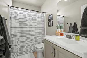 Full bath featuring vanity and curtained shower