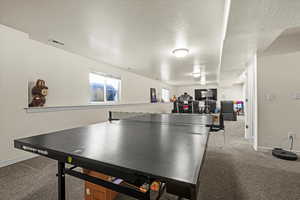 Rec room featuring a textured ceiling