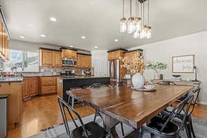 Dining space with light wood-style flooring and recessed lighting