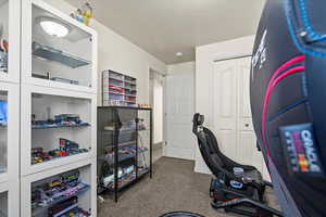Home office featuring dark carpet and baseboards