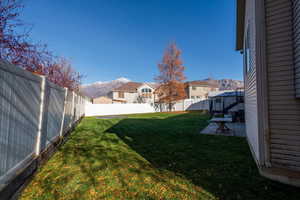 Fenced backyard featuring a patio and a mountain view