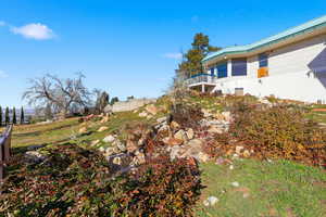 View of yard with a balcony
