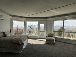 Carpeted bedroom with a wall unit AC, access to exterior, and a mountain view