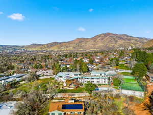 Aerial view of property's location with a mountainous background and nearby suburban area