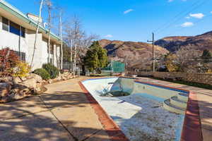 View of swimming pool with a mountain view, a fenced backyard, and a patio area