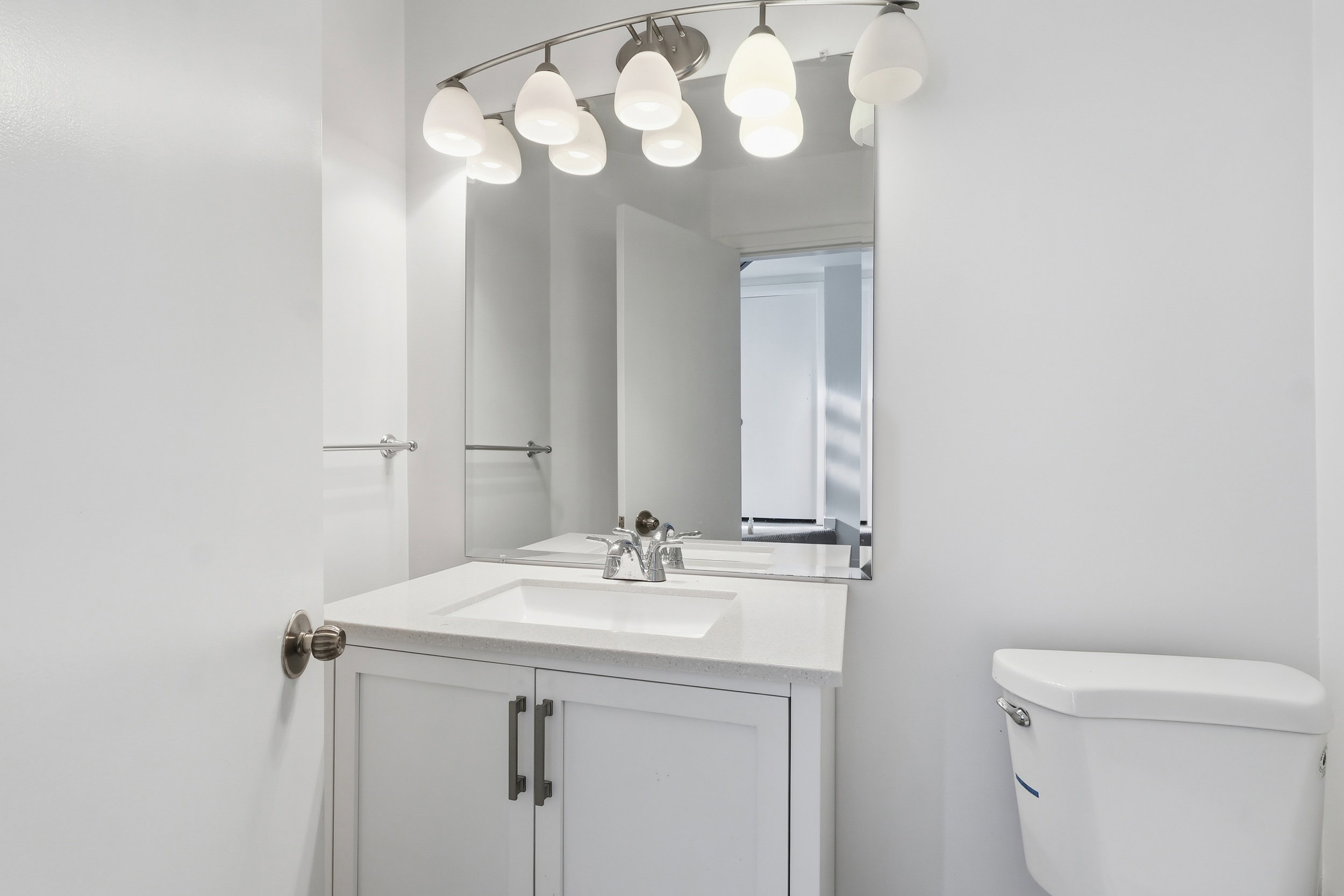 Half bath featuring vanity and toilet