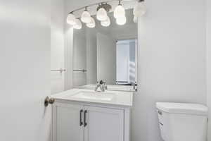 Half bath featuring vanity and toilet