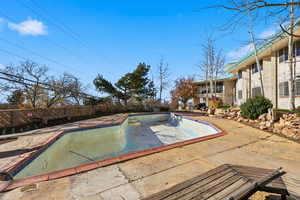 View of swimming pool with a patio area