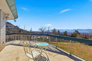 Deck featuring a mountain view and a patio