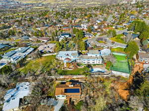 Aerial view of property and surrounding area featuring nearby suburban area
