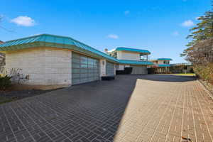 Garage featuring decorative driveway