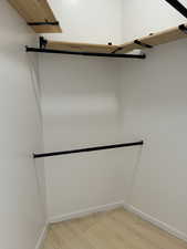 Walk in closet featuring light wood-type flooring