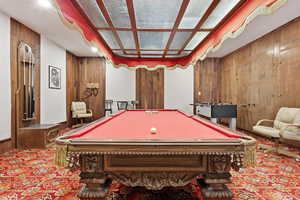 Rec room featuring wood walls, billiards table, and carpet flooring