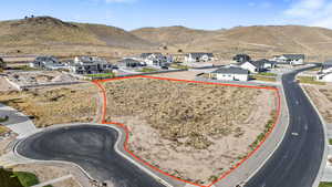 View of property location featuring mountains, property boundaries highlighted, and nearby suburban area
