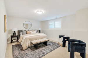 Bedroom with light carpet and baseboards