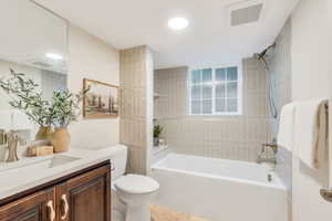 Bathroom with vanity and shower / tub combination