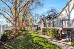 Fenced backyard featuring stairway and a wooden deck