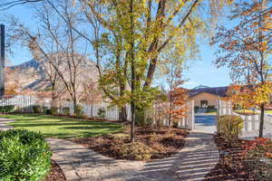 View of front of house with a fenced front yard and a mountain view