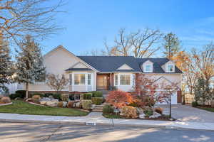 View of front facade featuring decorative driveway and a garage