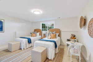 Bedroom featuring baseboards and carpet