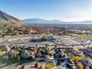Aerial view of property's location featuring a mountain backdrop and nearby suburban area
