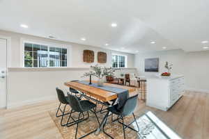 Dining area with light wood-type flooring and recessed lighting