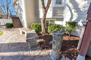 View of home's exterior featuring stairway and a patio area