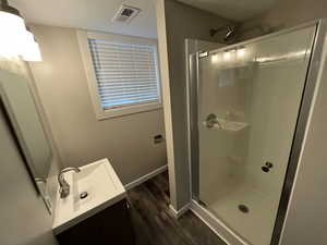 Bathroom with vanity, a stall shower, dark wood-type flooring, and a textured ceiling
