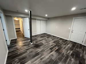 Unfurnished bedroom featuring dark wood finished floors, recessed lighting, and a closet