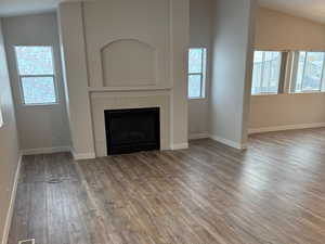 With its vaulted ceiling, ceiling fan, and ample natural light, this roomy living area is perfect for entertaining.