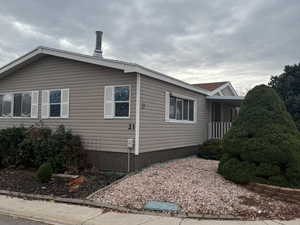 The side of the property showcases the home's durable siding and attractive skirting.