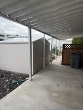 View of patio featuring a storage unit