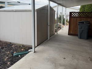 The storage shed is conveniently located right off the patio/carport area.