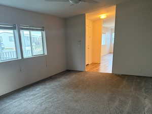 Spacious, carpeted living room situated to the left of the front entrance, has an abundant natural light.