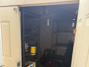 Storage shed with a cement floor and lockable door.