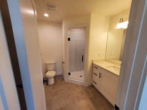 Full bathroom featuring a stall shower, vanity, and recessed lighting