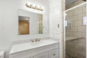 Bathroom featuring a stall shower and vanity