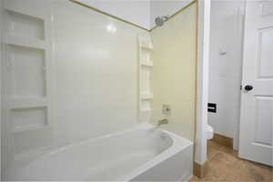 Full bath with shower / washtub combination and toilet