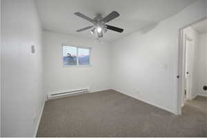 Unfurnished room with a baseboard heating unit, carpet, and a ceiling fan