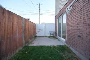 Fenced backyard with a patio