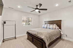 Bedroom with light carpet, a ceiling fan, and recessed lighting