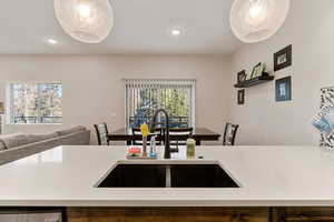 Kitchen featuring recessed lighting, open floor plan, and light stone counters