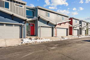 View of front facade with a residential view and an attached garage