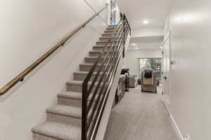 Staircase featuring carpet and recessed lighting