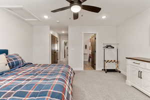 Bedroom with attic access, light carpet, a ceiling fan, recessed lighting, and a closet