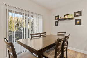 Dining space with wood finished floors and baseboards