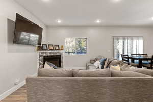 Living area with wood finished floors, recessed lighting, and plenty of natural light