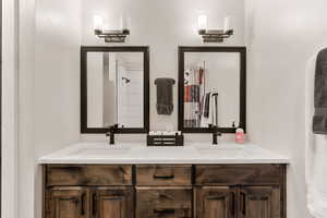 Full bath featuring double vanity and a shower with shower curtain